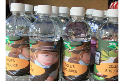 Bottled water with labels featuring illustrations from a cartoon about bugs, named "cole's bug juice.